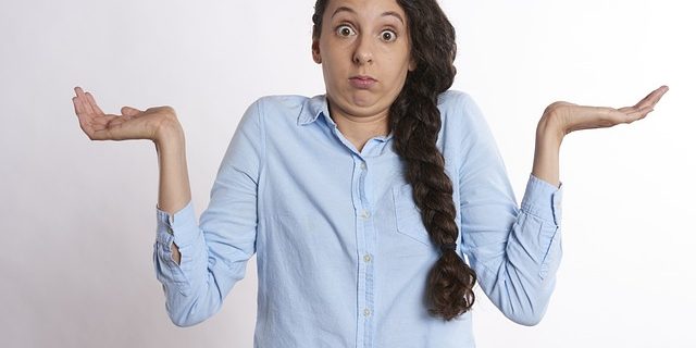woman with arms up in confusion