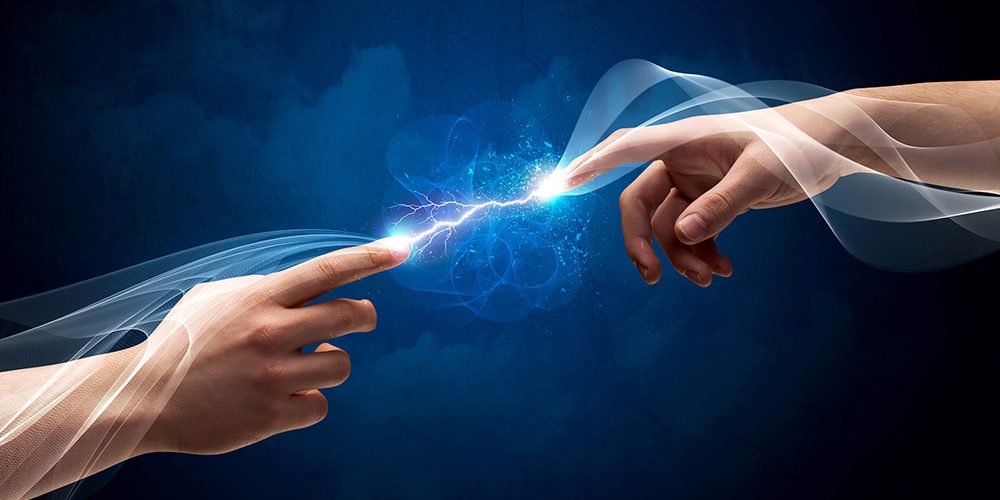 Small electrical exchange between two hands reaching towards each other