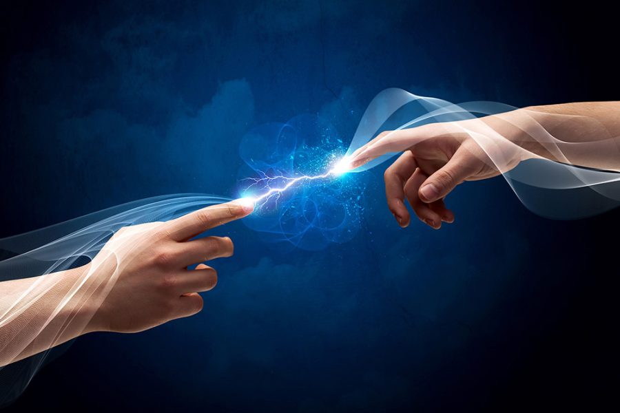 Small electrical exchange between two hands reaching towards each other
